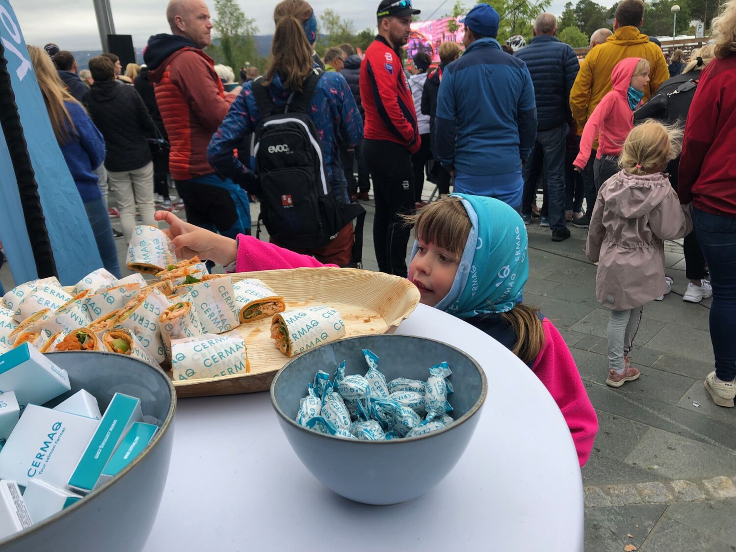 Liten jente som strekker seg etter en lakse-wrap
